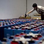 Rows of battery storage cells being inspected in an energy storage facility